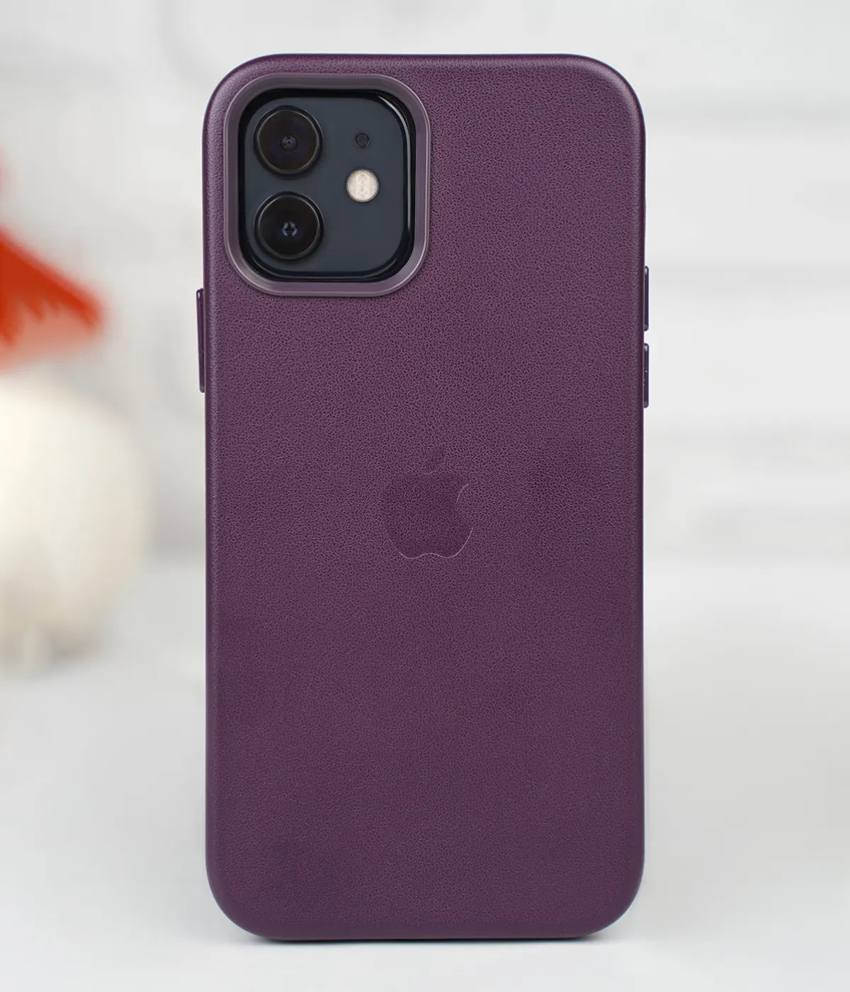 Full back view of an iPhone protected by the premium purple leather case, featuring a sleek design and an embossed Apple logo.