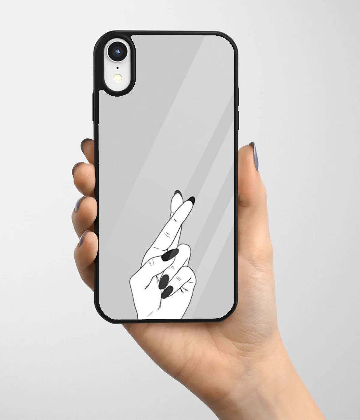 A hand holding a glass phone case with a colorful design.