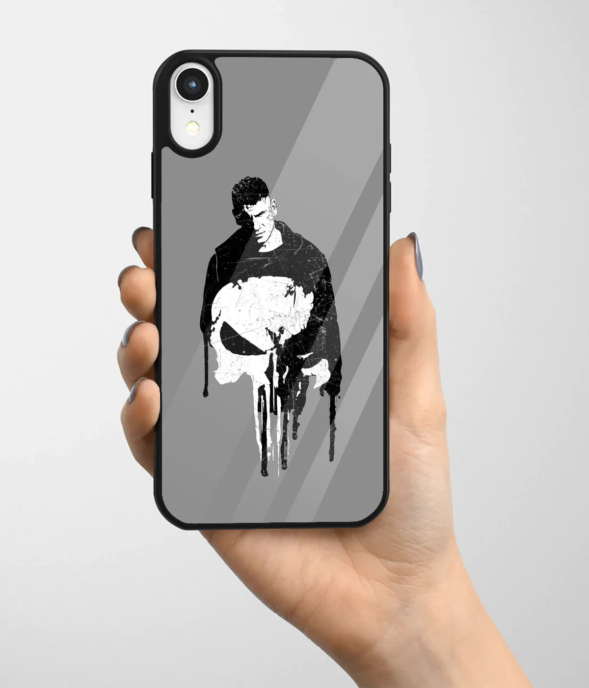 A hand holding a glass phone case with a colorful design.