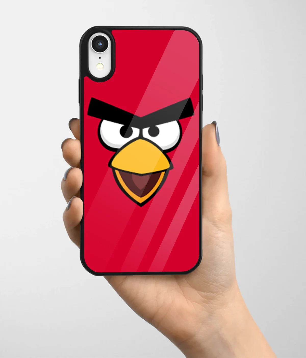 A hand holding a glass phone case with a colorful design.