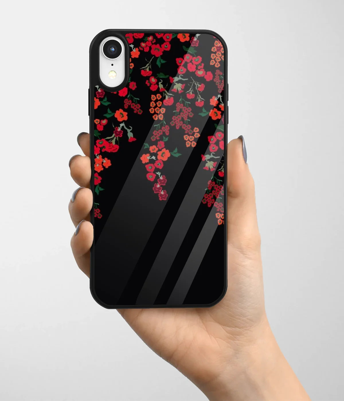 A hand holding a glass phone case with a colorful design.