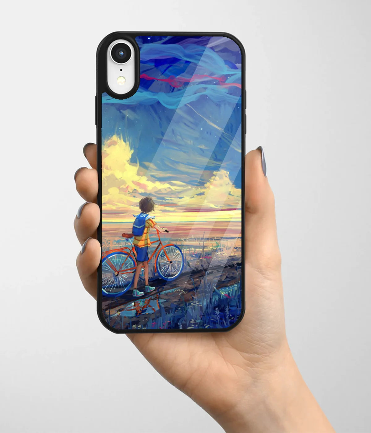 A hand holding a glass phone case with a colorful design.