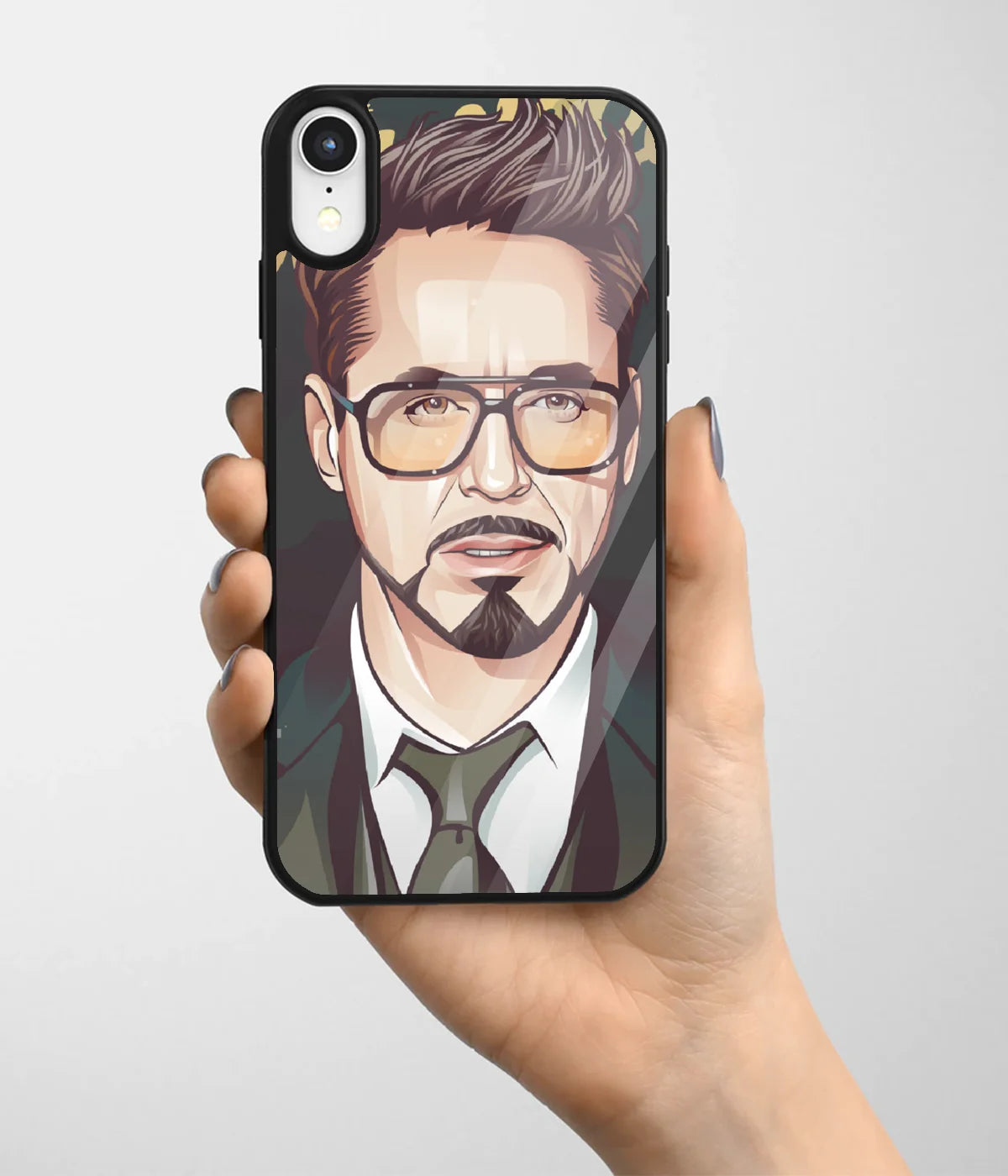 A hand holding a glass phone case with a colorful design.