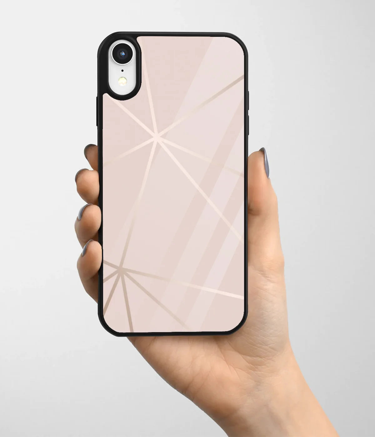 A hand holding a glass phone case with a colorful design.