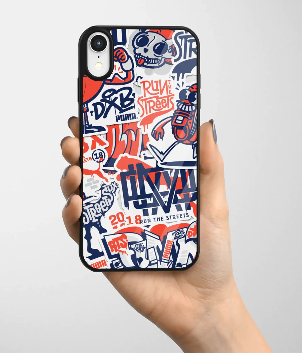 A hand holding a glass phone case with a colorful design.