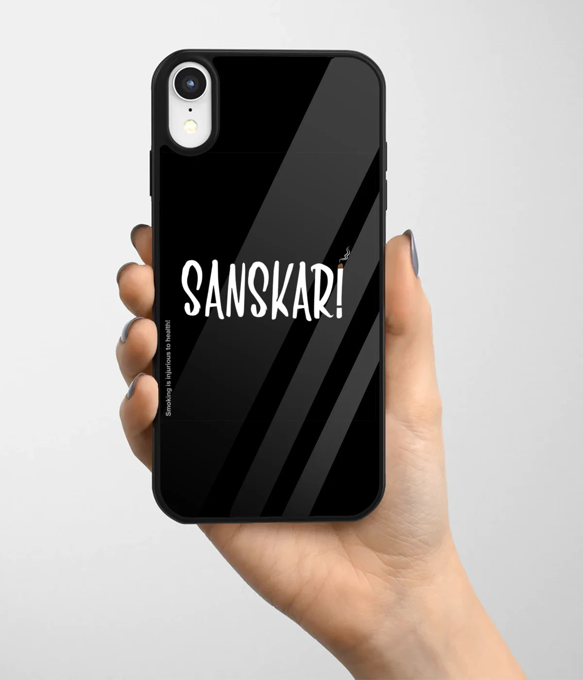 A hand holding a glass phone case with a colorful design.