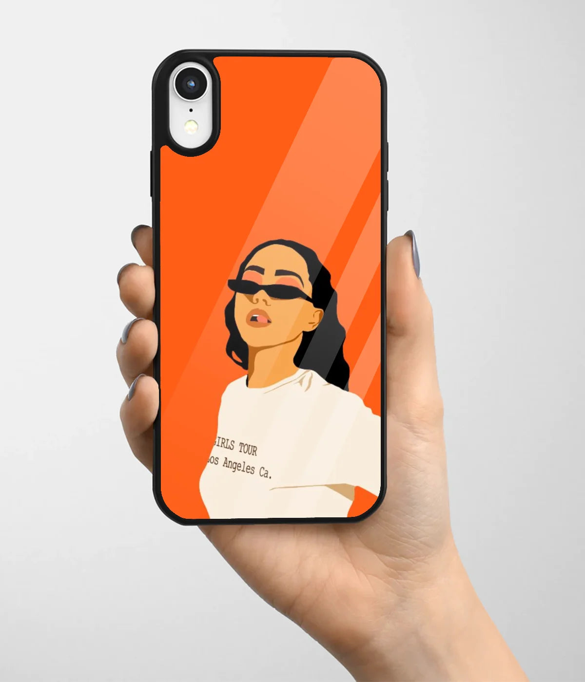 A hand holding a glass phone case with a colorful design.