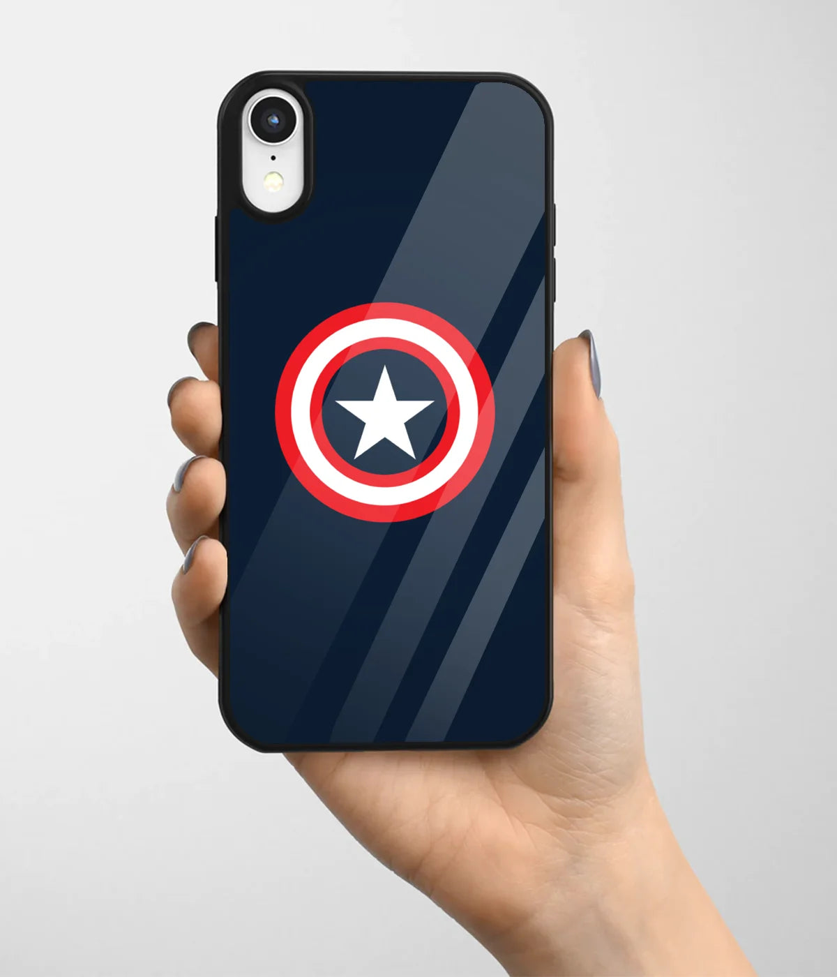 A hand holding a glass phone case with a colorful design.