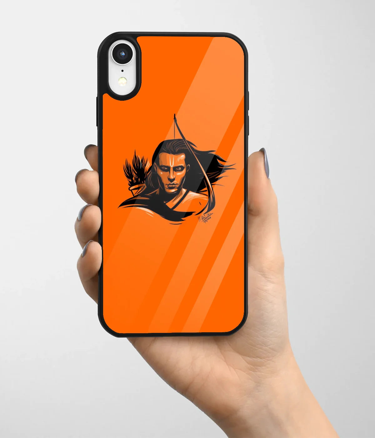 A hand holding a glass phone case with a colorful design.
