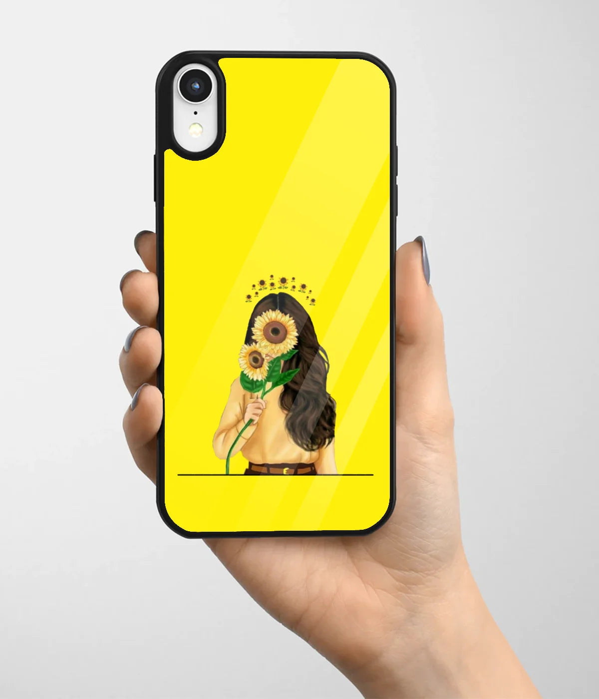 A hand holding a glass phone case with a colorful design.