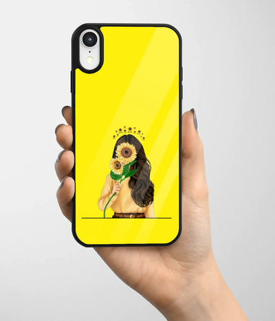 A hand holding a glass phone case with a colorful design.