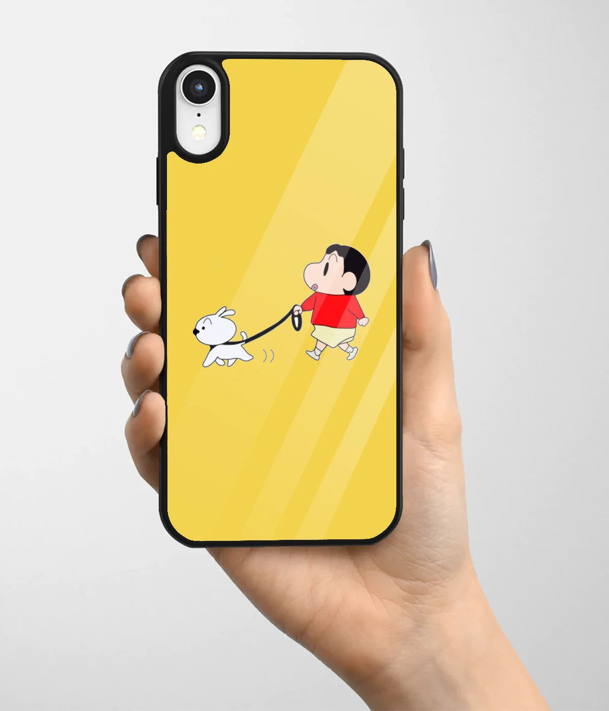 A hand holding a glass phone case with a colorful design.