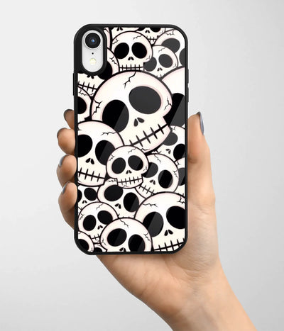 A hand holding a glass phone case with a colorful design.