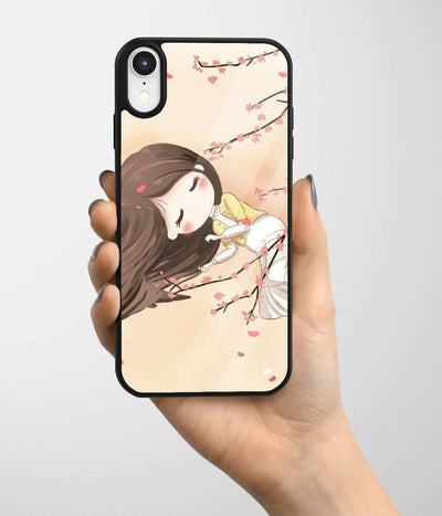 A hand holding a glass phone case with a colorful design.