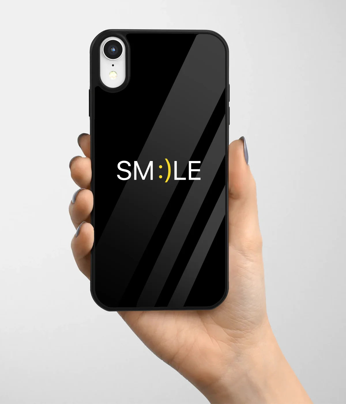 A hand holding a glass phone case with a colorful design.
