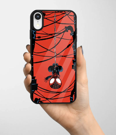 A hand holding a glass phone case with a colorful design.