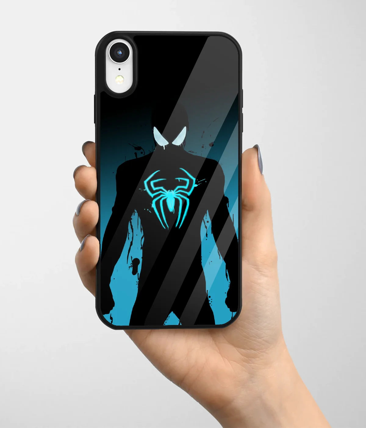 A hand holding a glass phone case with a colorful design.