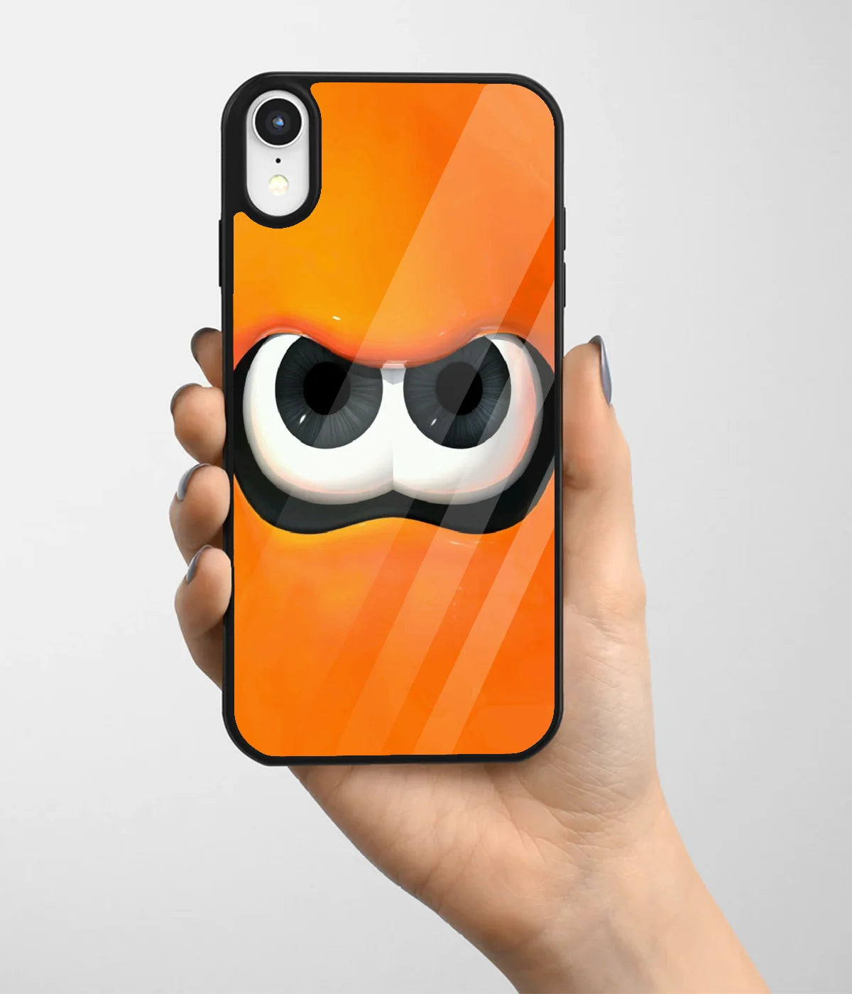 A hand holding a glass phone case with a colorful design.