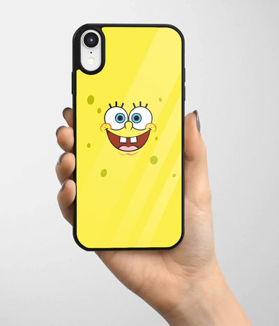 A hand holding a glass phone case with a colorful design.