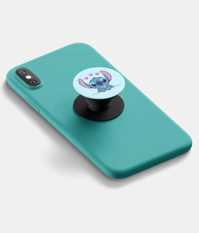 A top-down view of a phone grip holder attached to a mobile phone case on a white background