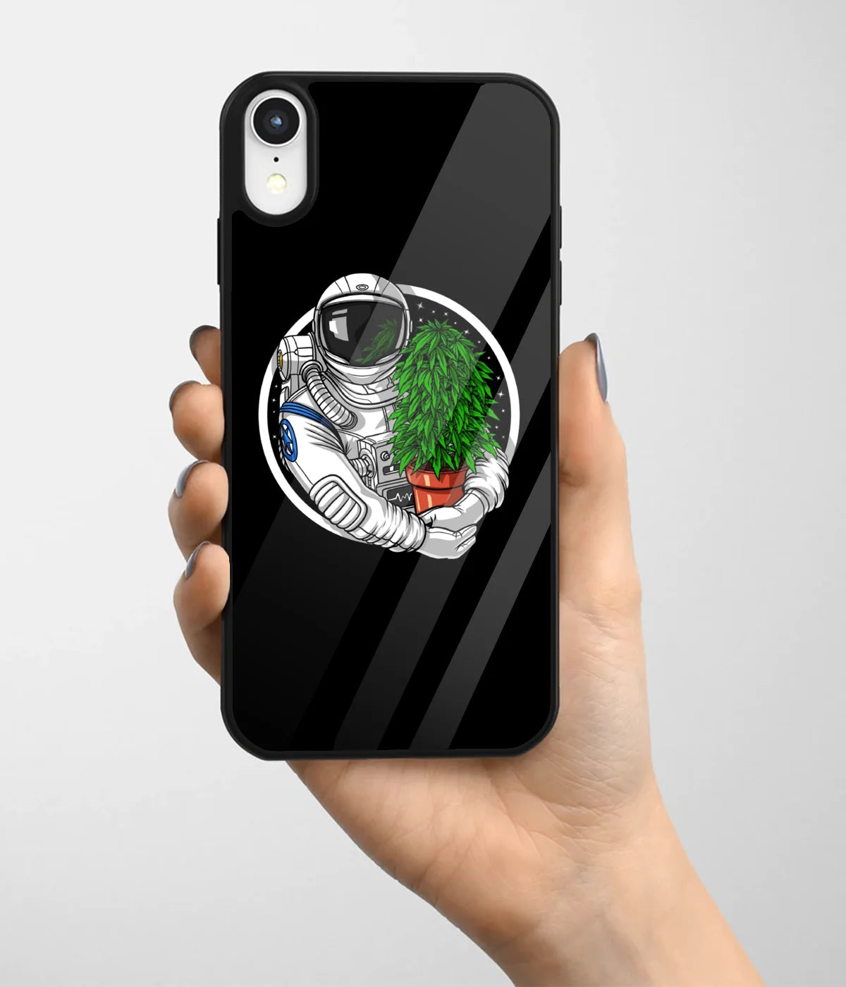 A hand holding a glass phone case with a colorful design.