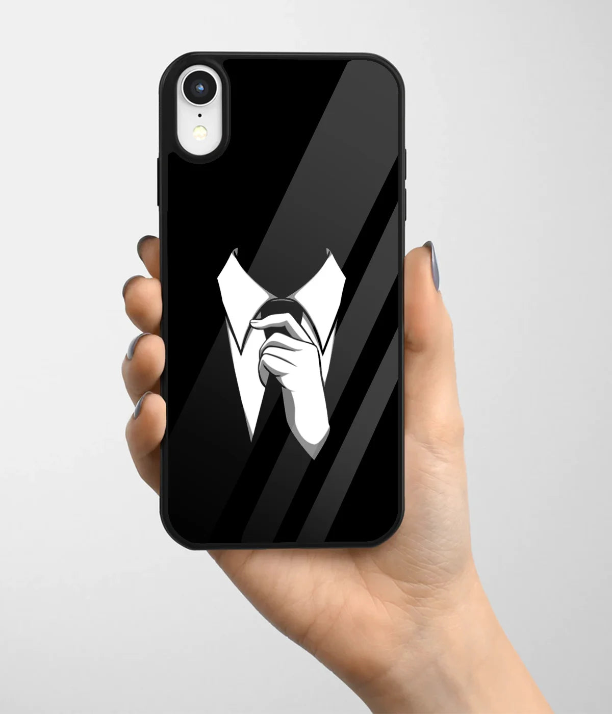 A hand holding a glass phone case with a colorful design.