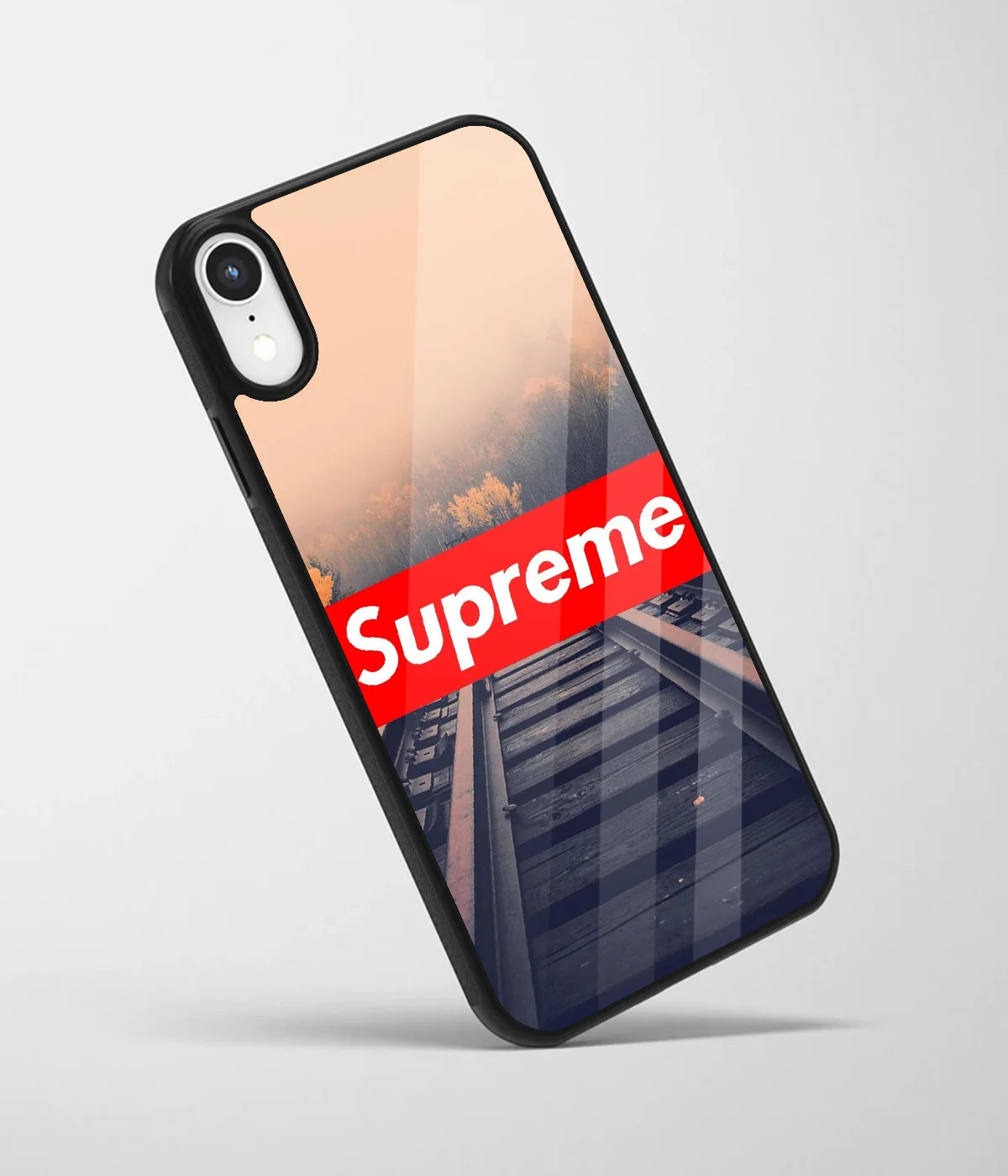 An angled view of a glass phone case featuring a vibrant design.