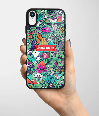 A hand holding a glass phone case with a colorful design.