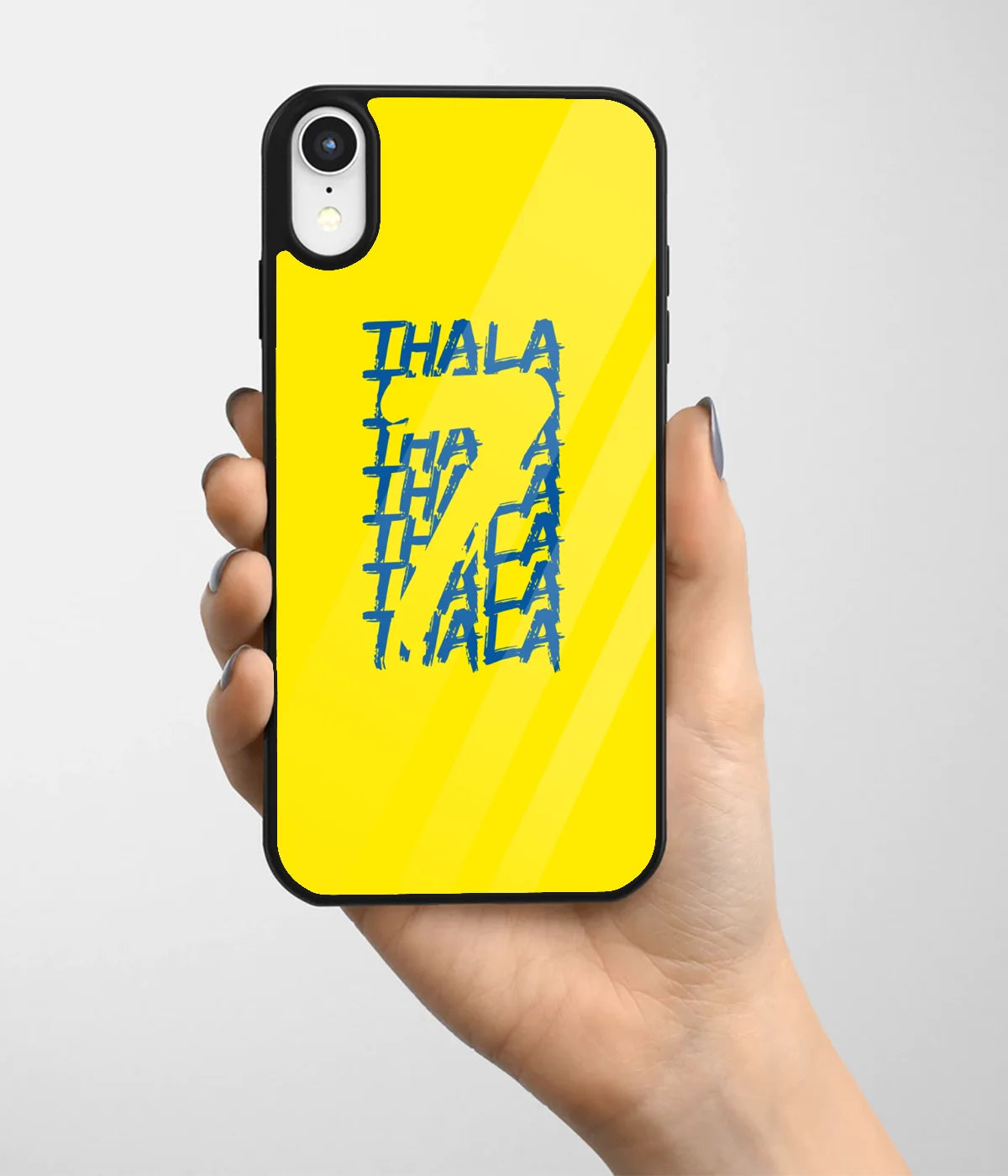 A hand holding a glass phone case with a colorful design.