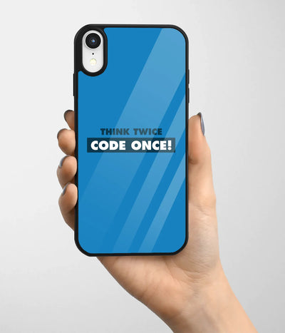 A hand holding a glass phone case with a colorful design.