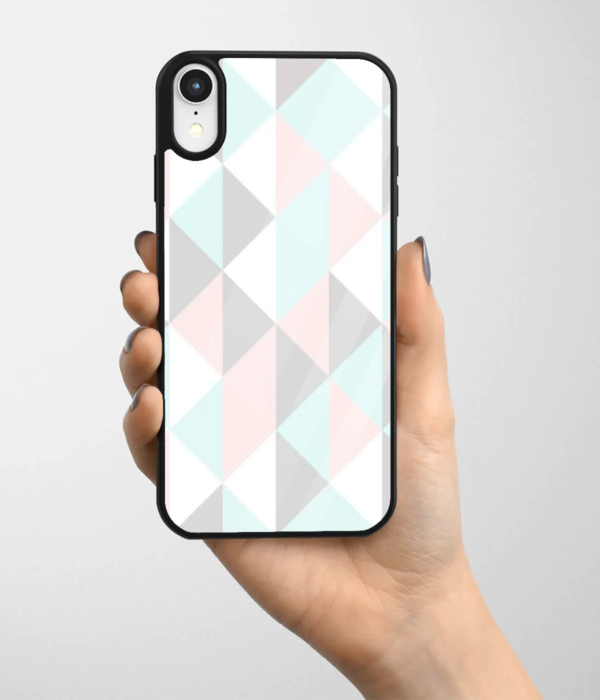A hand holding a glass phone case with a colorful design.