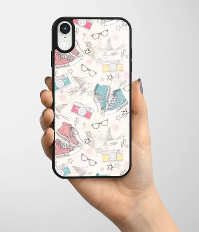 A hand holding a glass phone case with a colorful design.