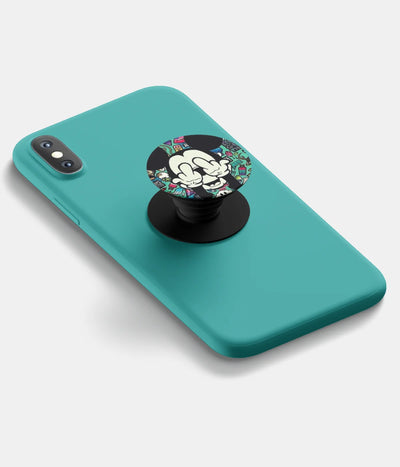 A top-down view of a phone grip holder attached to a mobile phone case on a white background