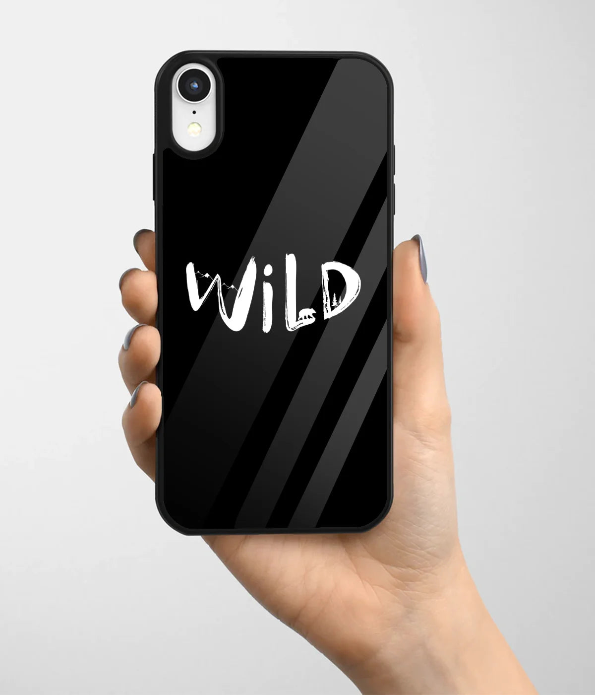 A hand holding a glass phone case with a colorful design.