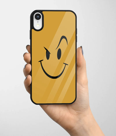 A hand holding a glass phone case with a colorful design.