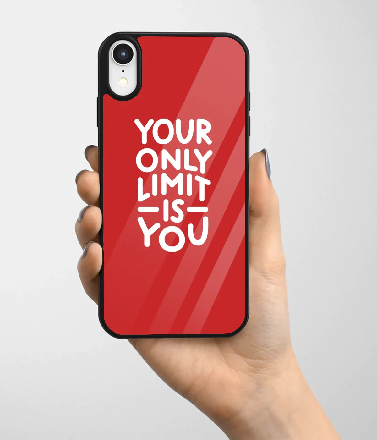 A hand holding a glass phone case with a colorful design.